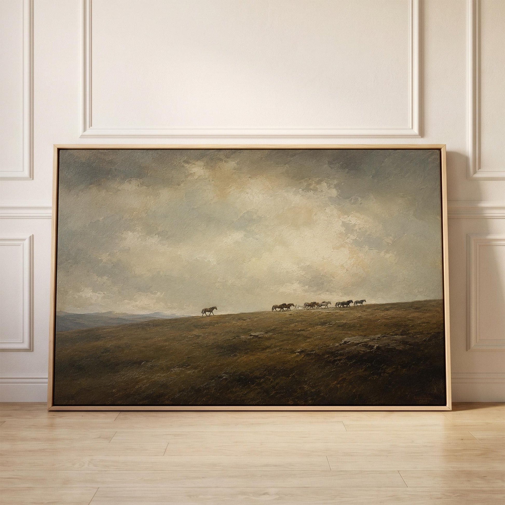 Distant herd of horses crossing a ridge under a vast cloudy sky, canvas print held up against a sunlit bedroom wall