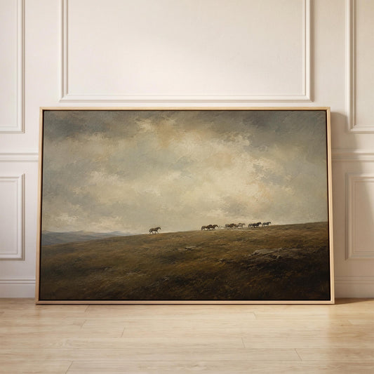 Distant herd of horses crossing a ridge under a vast cloudy sky, canvas print held up against a sunlit bedroom wall