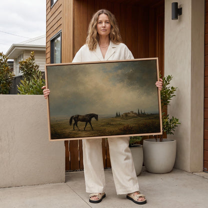 Dark horse in a meadow below a Tuscan villa with cypresses, canvas print seen in a warm interior with natural light