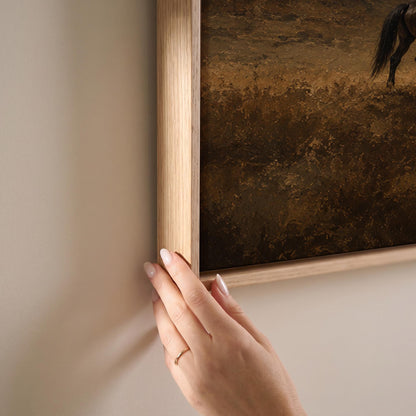 Dark horse grazing on a golden hillside below a Tuscan villa, canvas print shown at full size in a light-filled bedroom