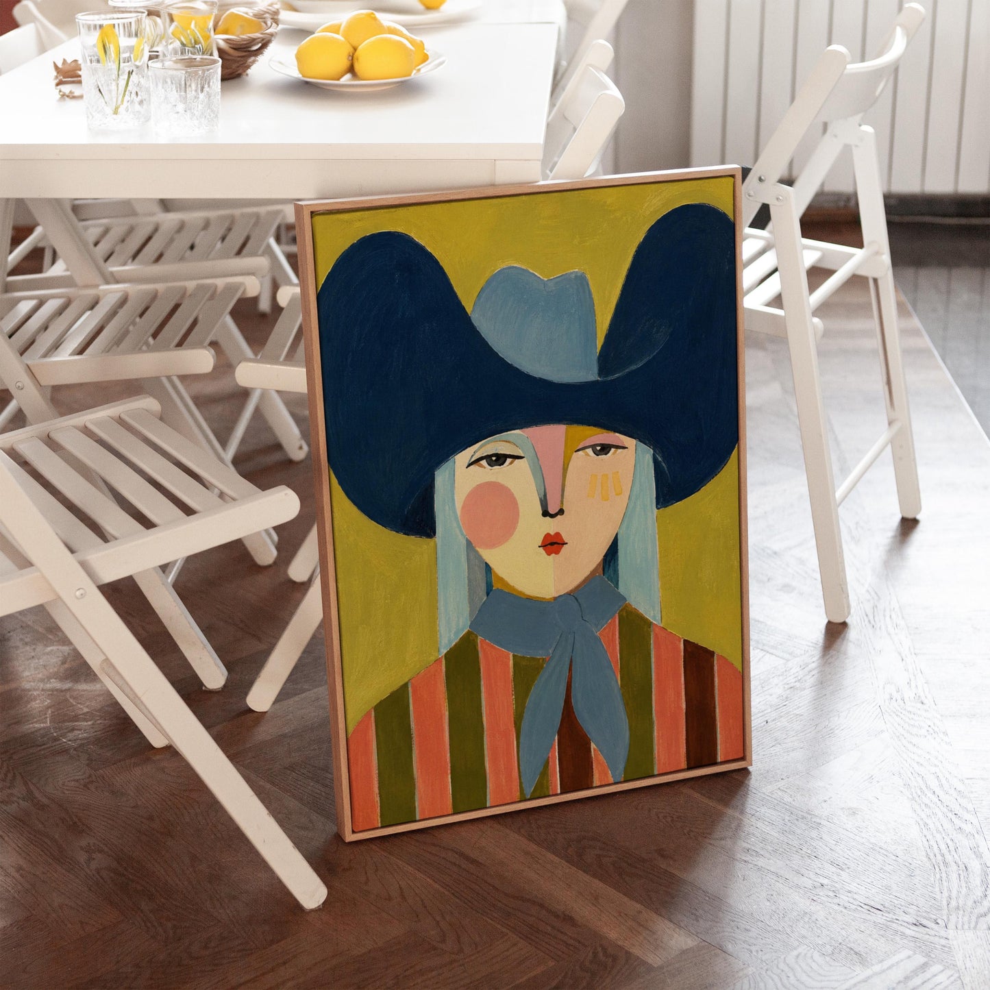 Folk cowgirl in an oversized navy hat and blue neckerchief on mustard, canvas print styled against a soft white wall
