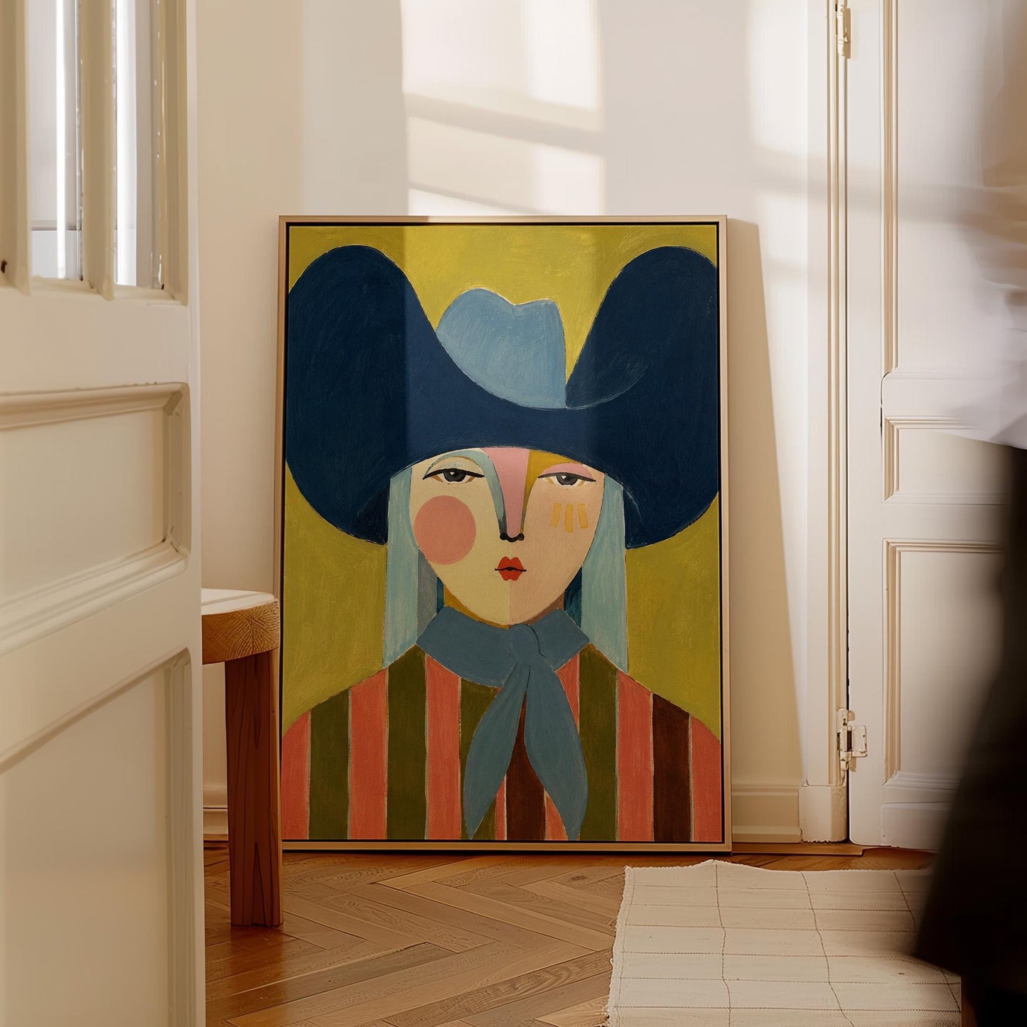 Folk cowgirl in an oversized navy hat and blue neckerchief on mustard, canvas wall art hanging in a calm, modern living space