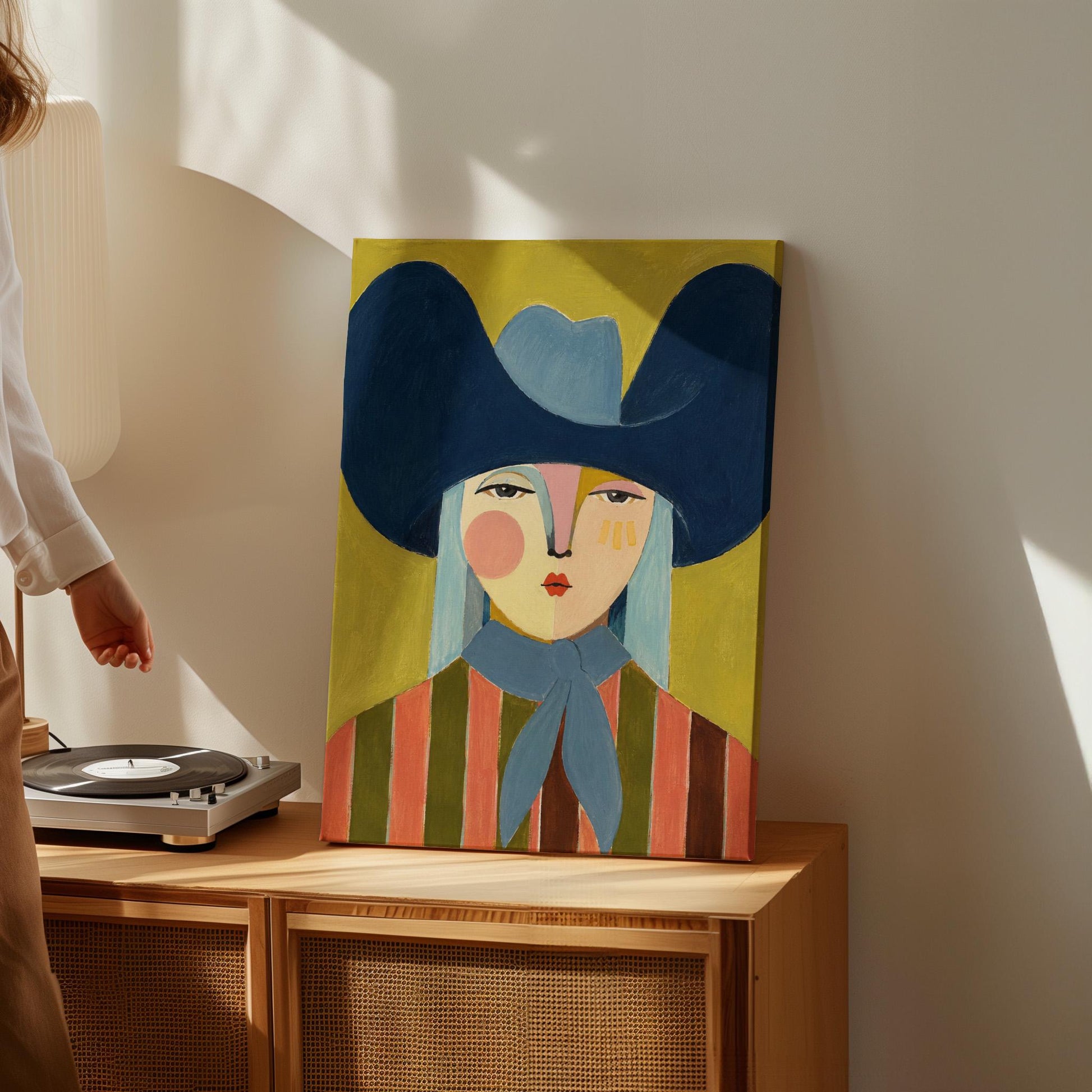 Folk cowgirl in an oversized navy hat and blue neckerchief on mustard, canvas wall art styled against a soft white wall