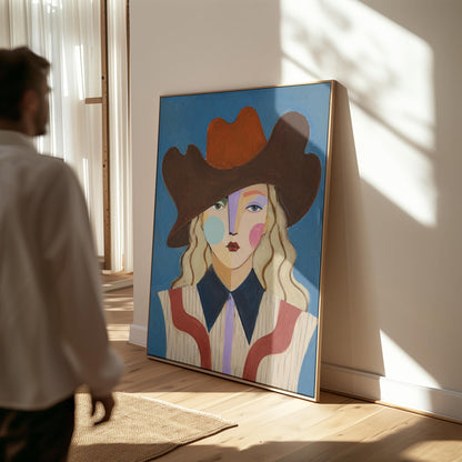 Blonde cowgirl in a rust cowboy hat with a cubist face on deep blue, canvas wall art hanging in a calm, modern living space