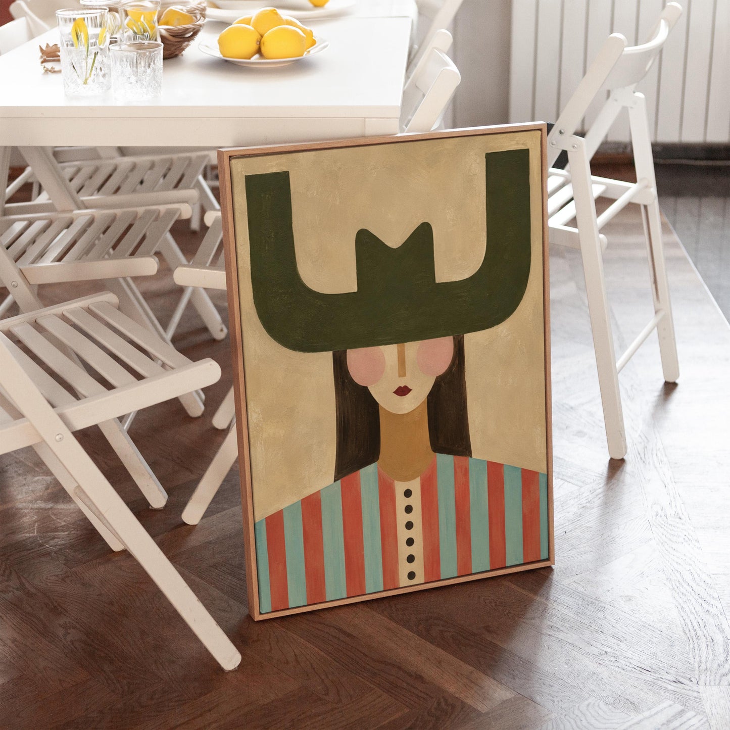 Minimal cowgirl with a bold green hat and red-teal striped shirt on cream, canvas print seen in a warm interior with natural light