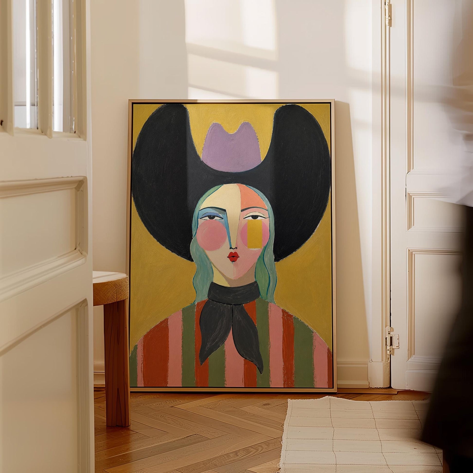 Folk cowgirl with teal hair, a big black hat and striped shirt on golden yellow, canvas wall art styled against a soft white wall