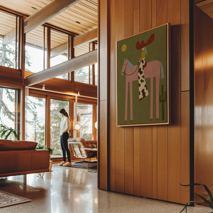 Cowgirl in a red hat riding a long-legged pink horse past a cactus at sunset, canvas print shown to scale in a furnished room