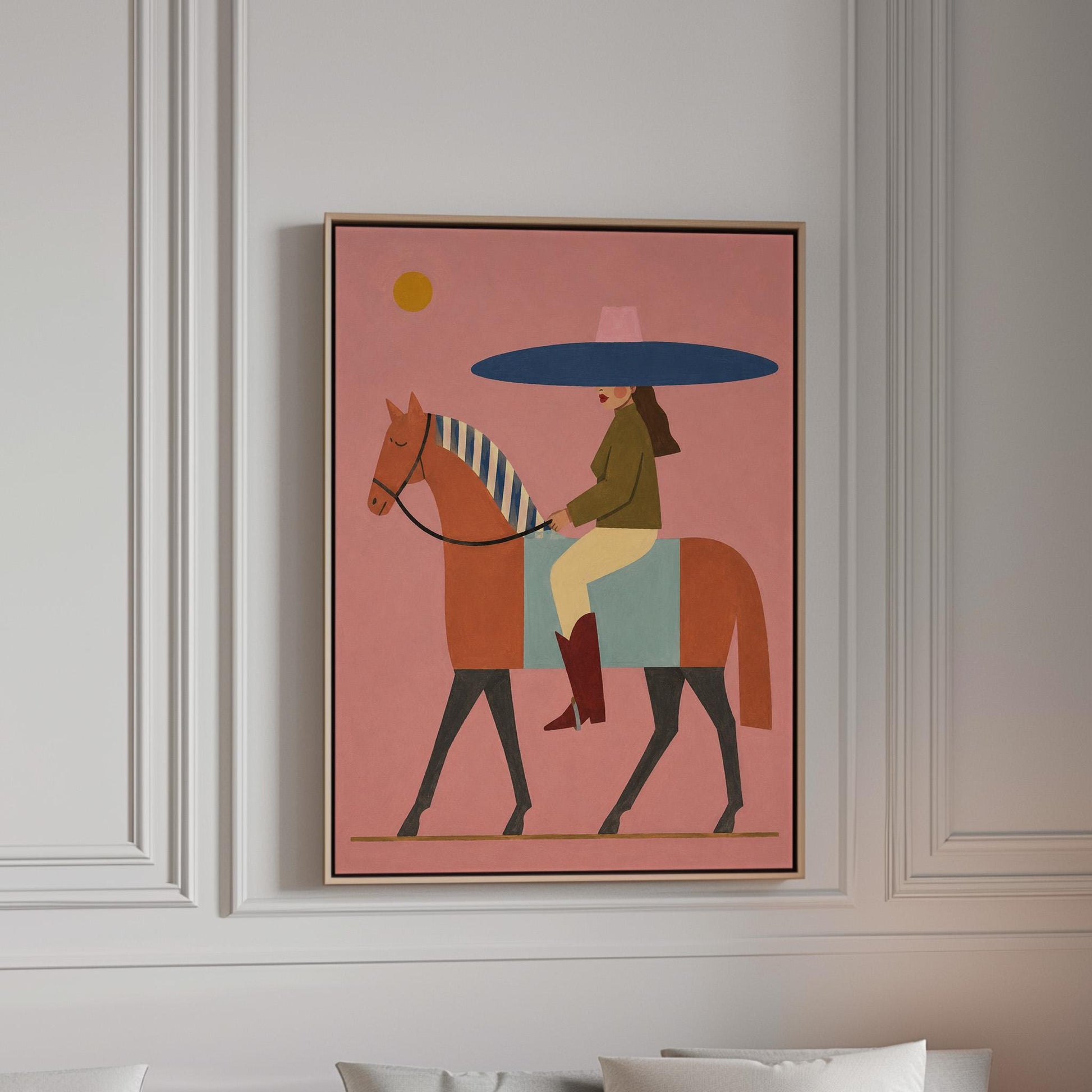 Woman in a wide navy hat riding a chestnut horse in profile on coral pink, canvas print in a bright room with natural daylight