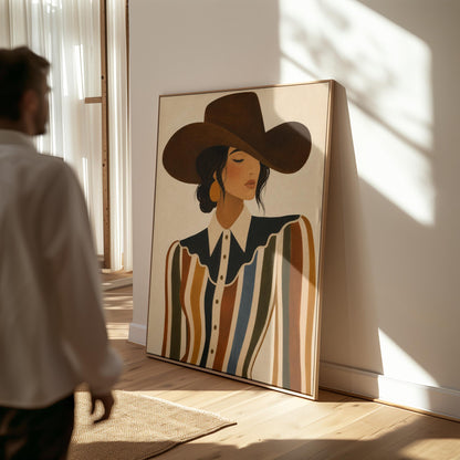 Cowgirl in a brown hat and rippling striped blouse with a black collar on cream, canvas print hanging in a calm, modern living space