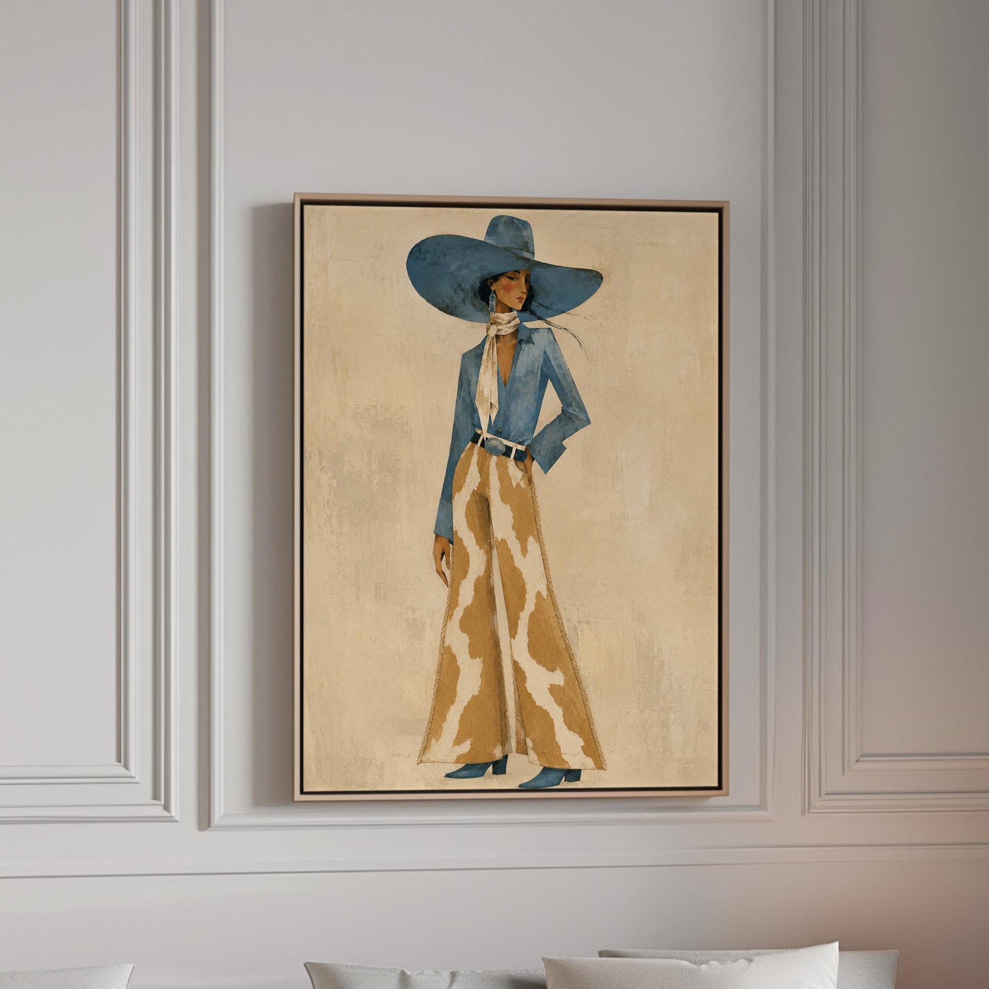 Full-figure cowgirl in a blue hat, denim shirt and cow-print flared pants on cream, canvas print in a bright room with natural daylight