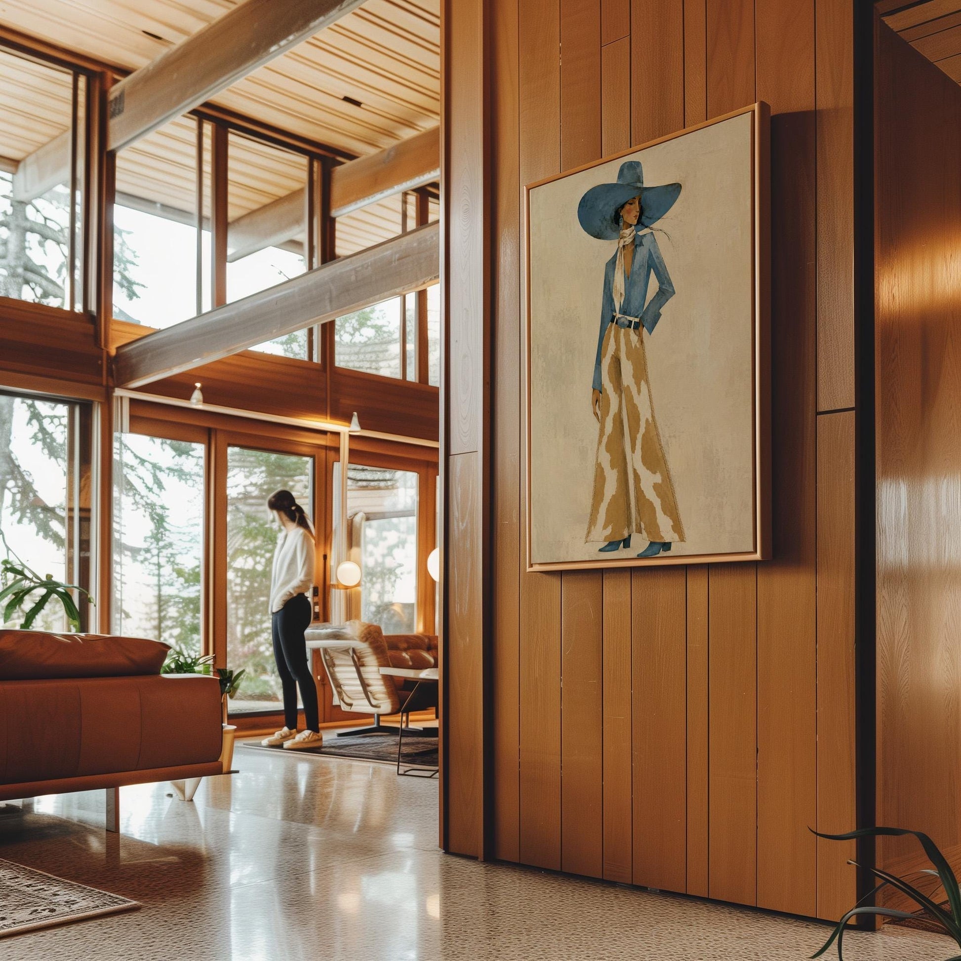 Full-figure cowgirl in a blue hat, denim shirt and cow-print flared pants on cream, canvas print hanging in a calm, modern living space