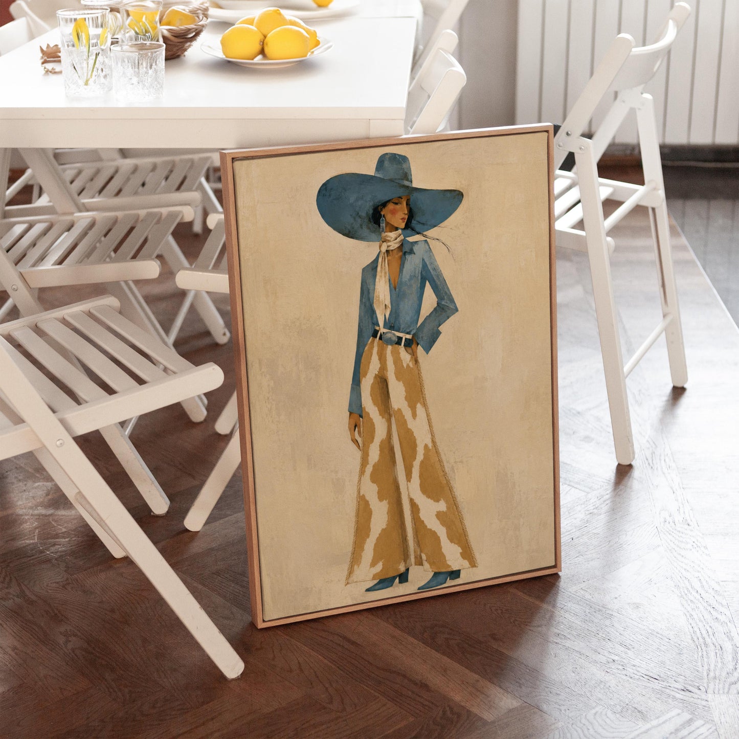 Full-figure cowgirl in a blue hat, denim shirt and cow-print flared pants on cream, canvas print seen in a warm interior with natural light