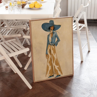 Full-figure cowgirl in a blue hat, denim shirt and cow-print flared pants on cream, canvas print seen in a warm interior with natural light