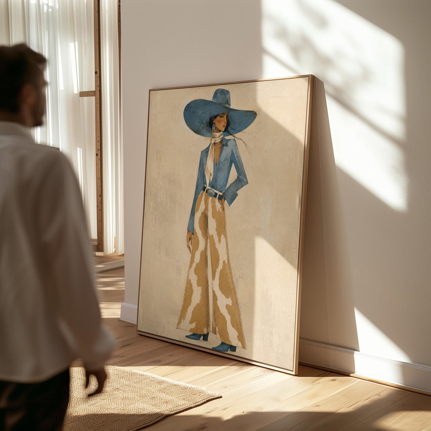 Full-figure cowgirl in a blue hat, denim shirt and cow-print flared pants on cream, canvas wall art seen in a warm interior with natural light