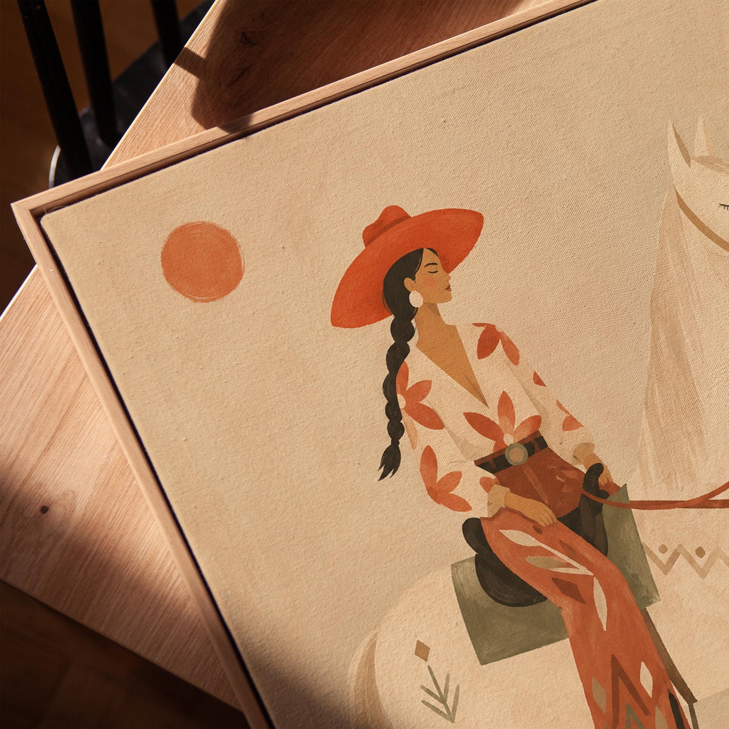 Cowgirl in a red hat sitting on a white horse beside a cactus in warm sand, canvas print in a warm, minimally styled interior