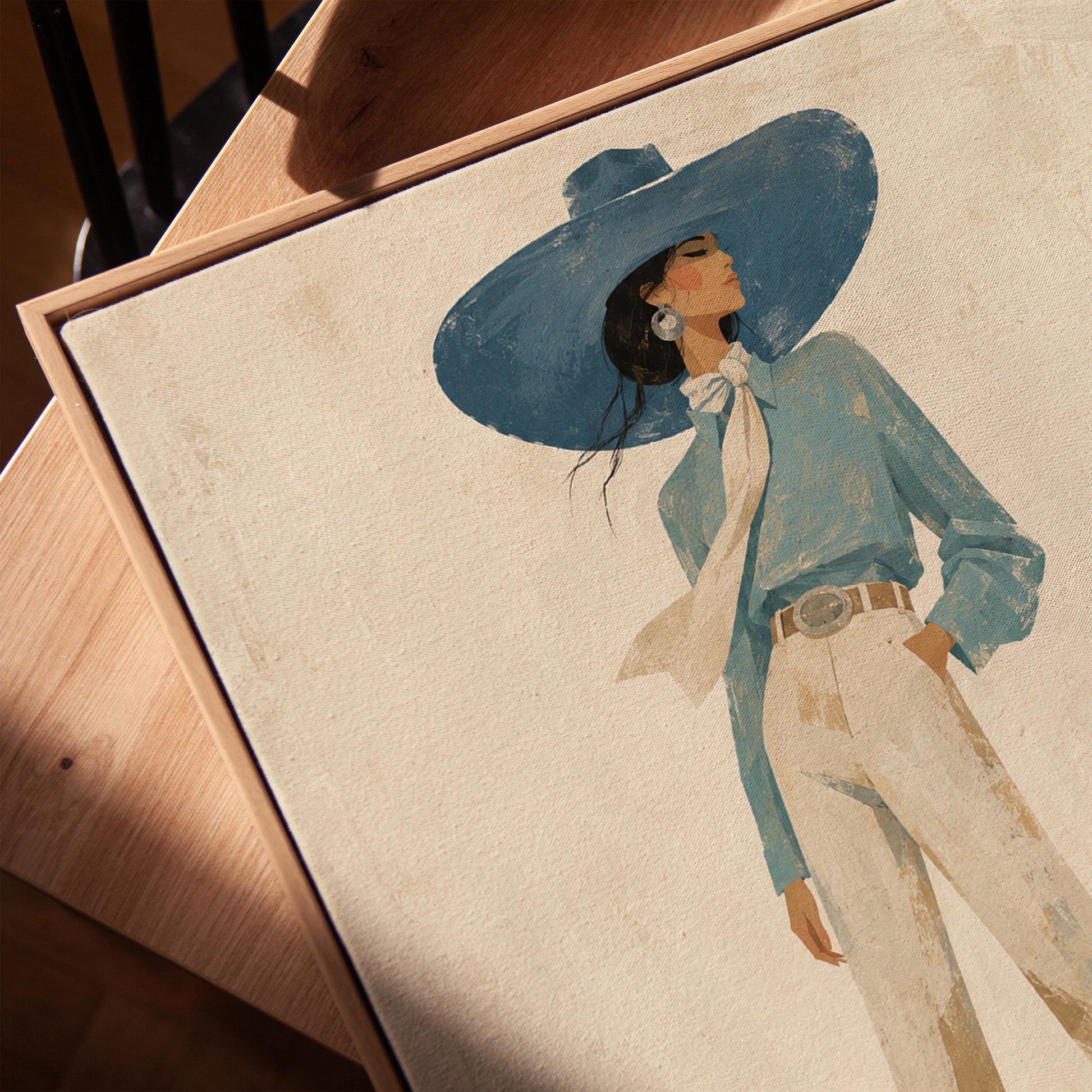 Full-figure cowgirl in a wide teal hat, blouse and boots with cream trousers, canvas print in a warm, minimally styled interior
