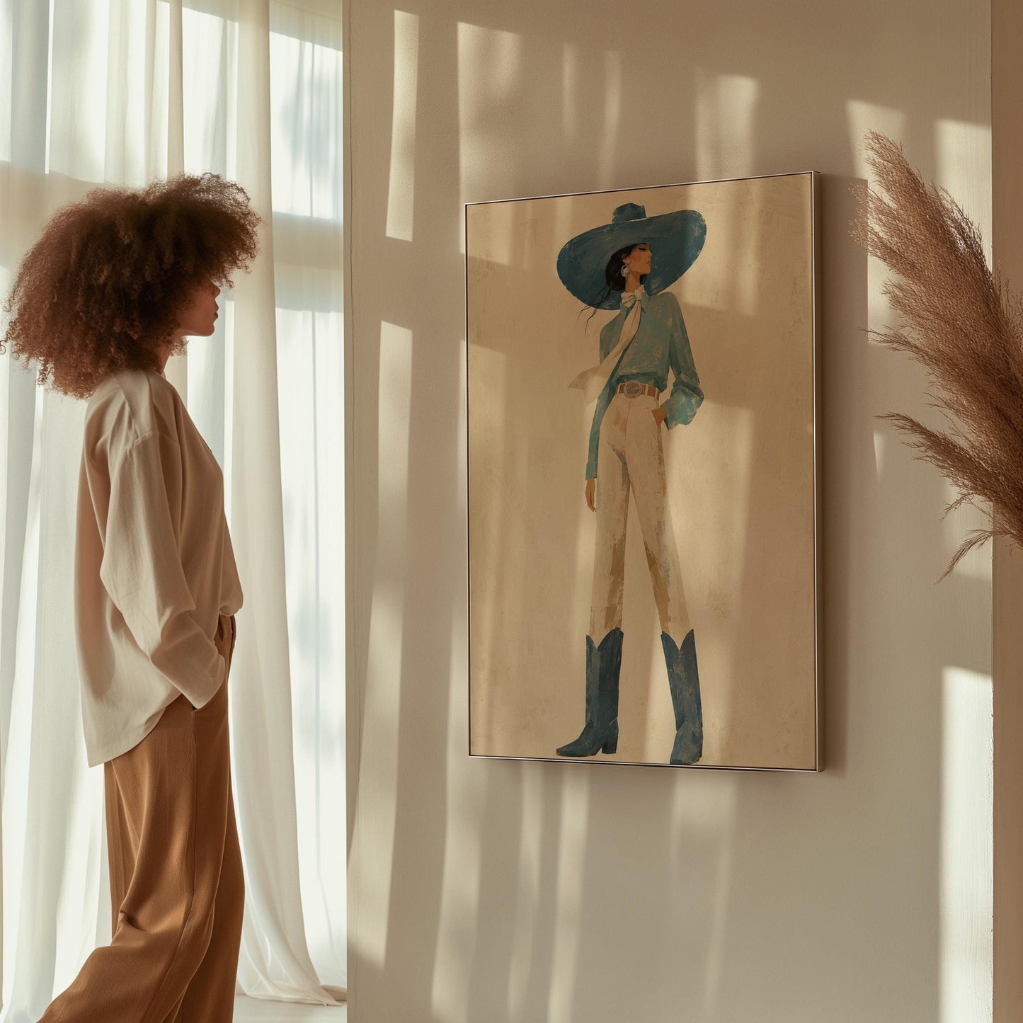 Full-figure cowgirl in a wide teal hat, blouse and boots with cream trousers, canvas wall art seen in a warm interior with natural light