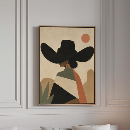 Cowgirl seen from behind in a large black hat and serape under a desert sun, canvas print in a bright room with natural daylight