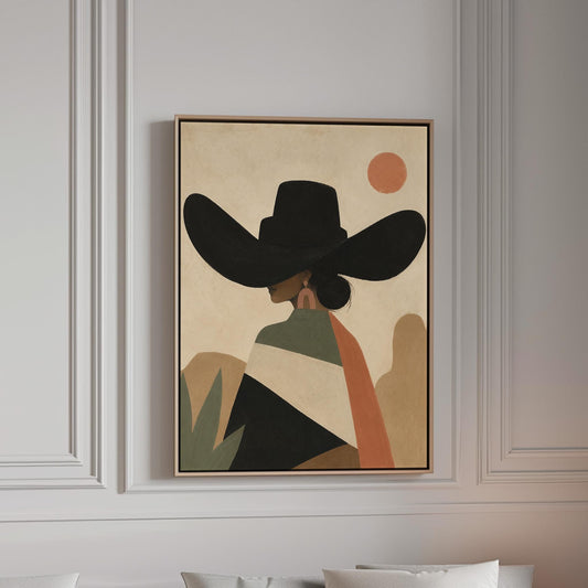 Cowgirl seen from behind in a large black hat and serape under a desert sun, canvas print in a bright room with natural daylight