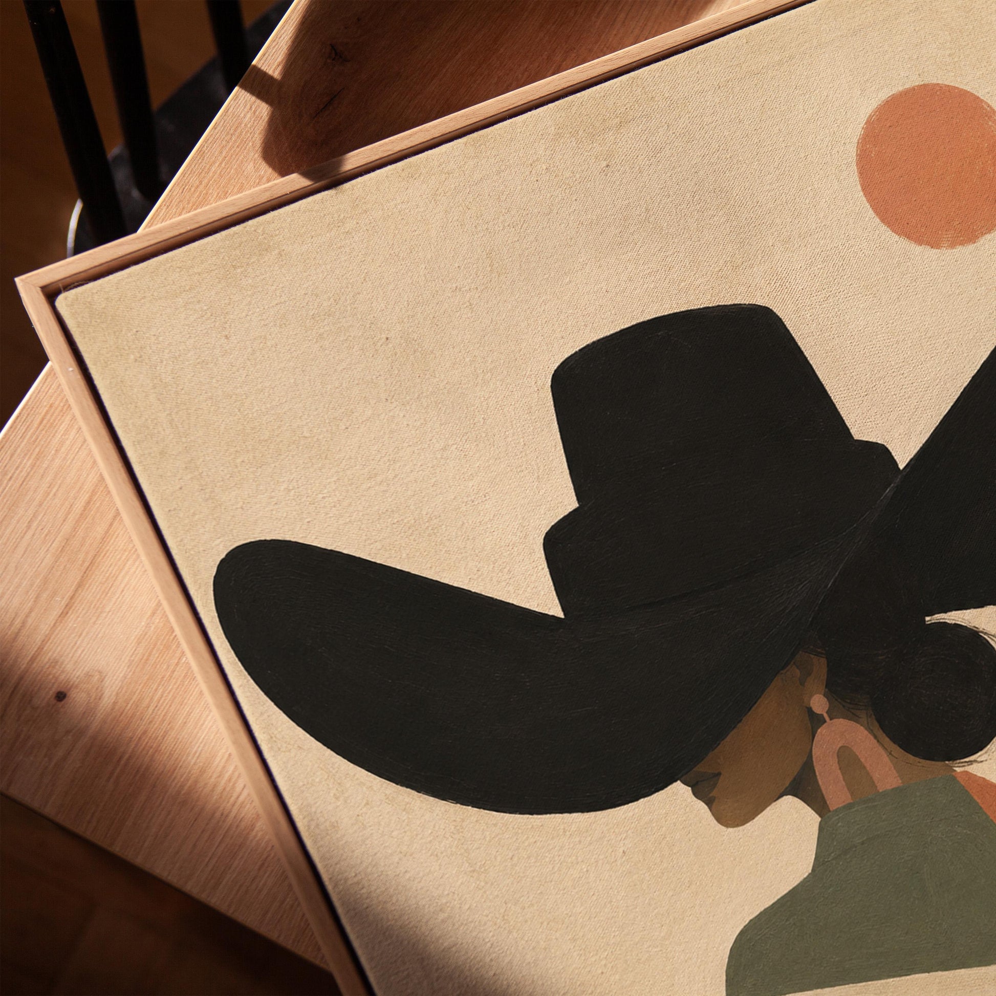 Cowgirl seen from behind in a large black hat and serape under a desert sun, canvas print in a warm, minimally styled interior
