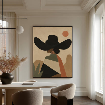 Cowgirl seen from behind in a large black hat and serape under a desert sun, canvas print presented in a light, minimal room