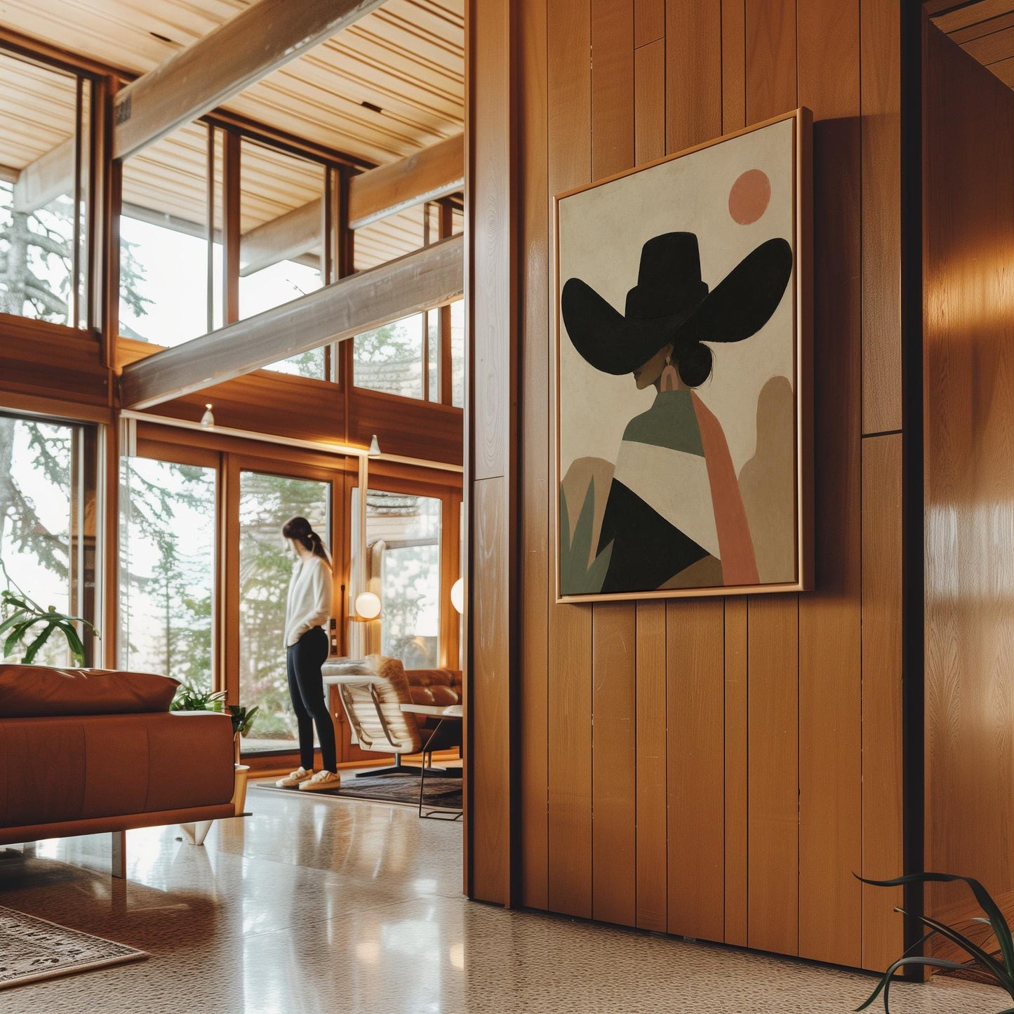 Cowgirl seen from behind in a large black hat and serape under a desert sun, canvas wall art styled against a soft white wall