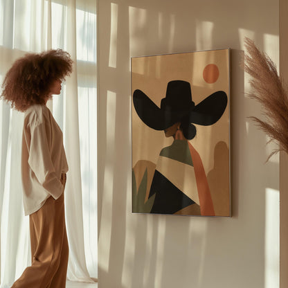 Cowgirl seen from behind in a large black hat and serape under a desert sun, canvas wall art presented in a light, minimal room