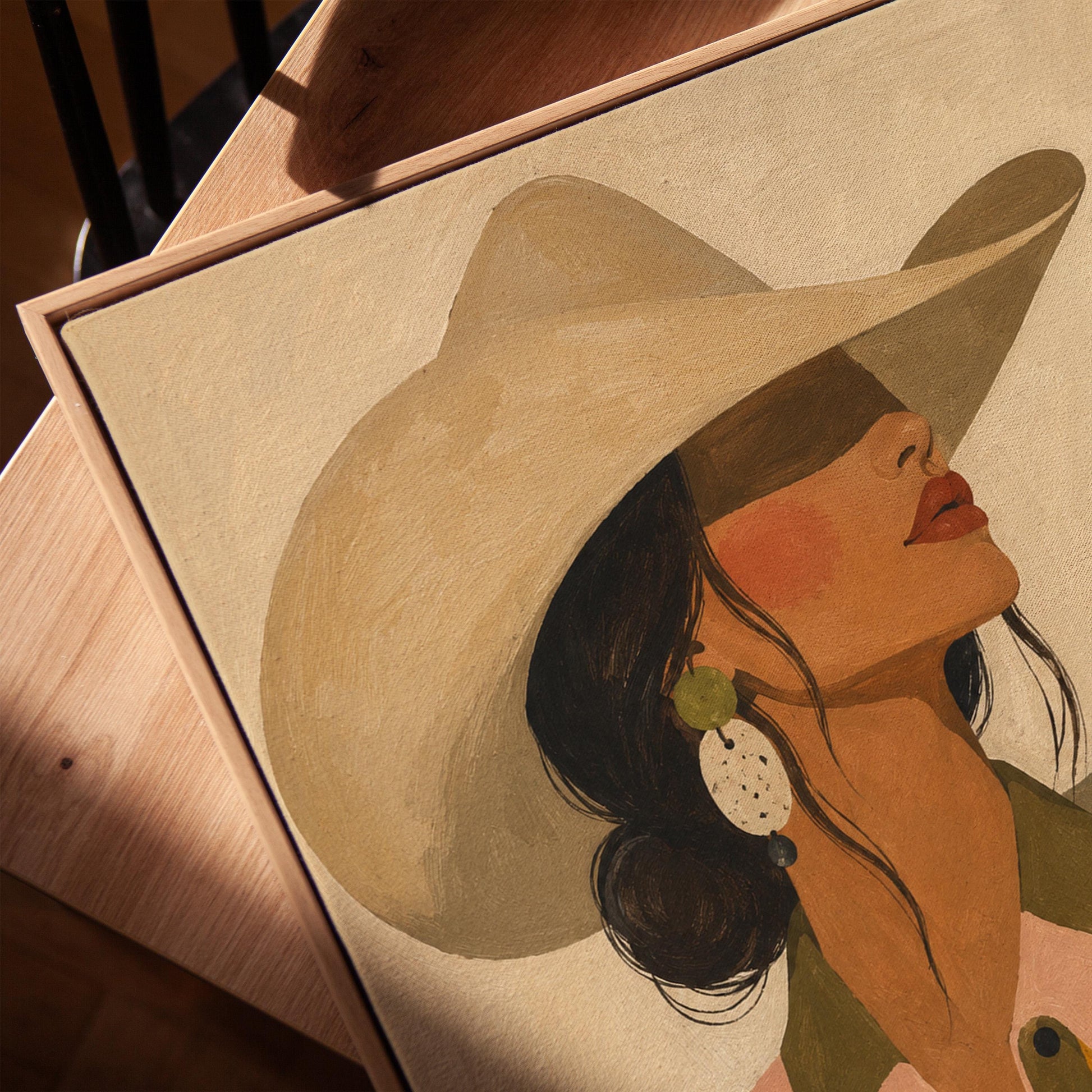 Cowgirl in profile in a cream hat and star-trimmed rodeo shirt by pink mountains, canvas print in a warm, minimally styled interior
