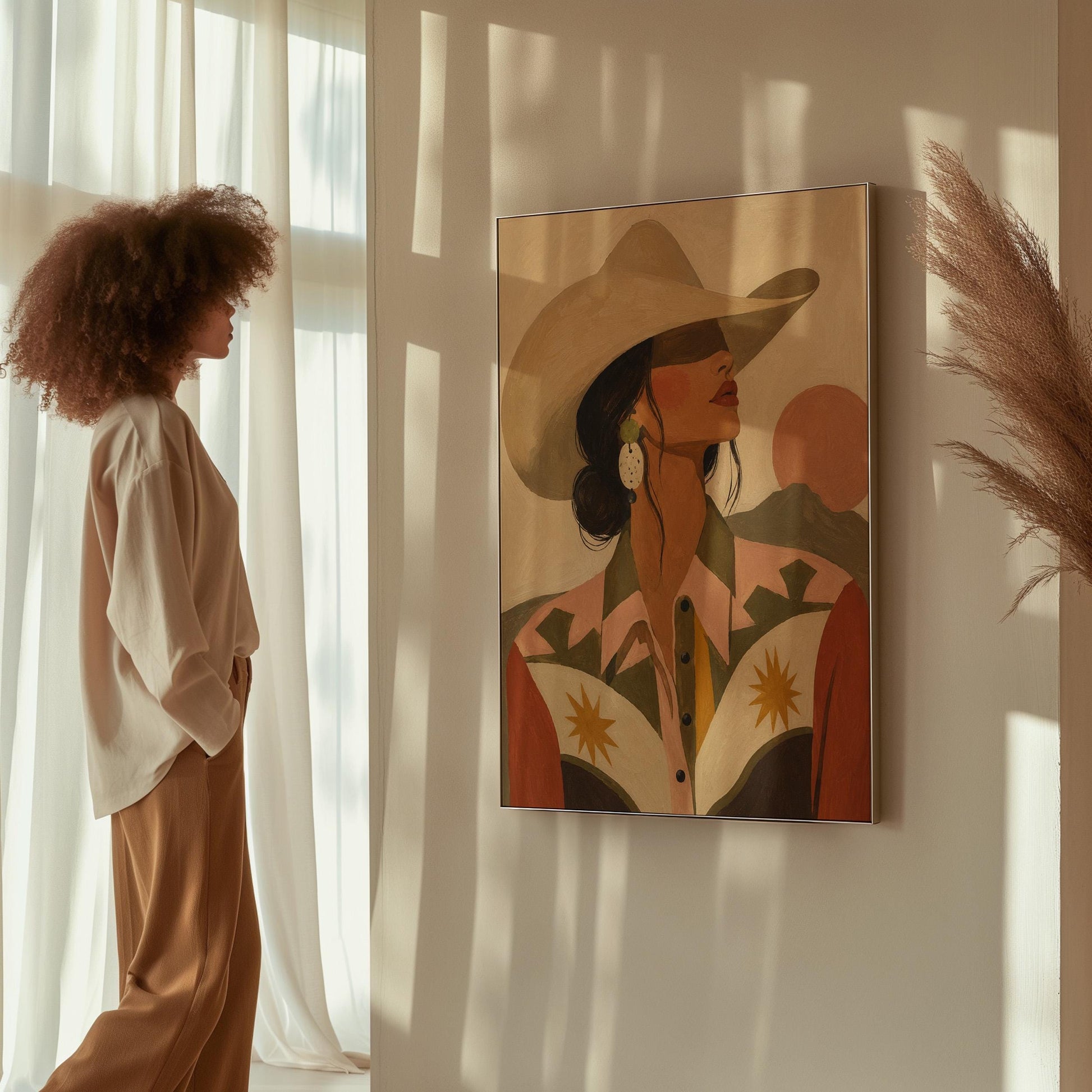 Cowgirl in profile in a cream hat and star-trimmed rodeo shirt by pink mountains, canvas print on a quiet wall in a considered interior