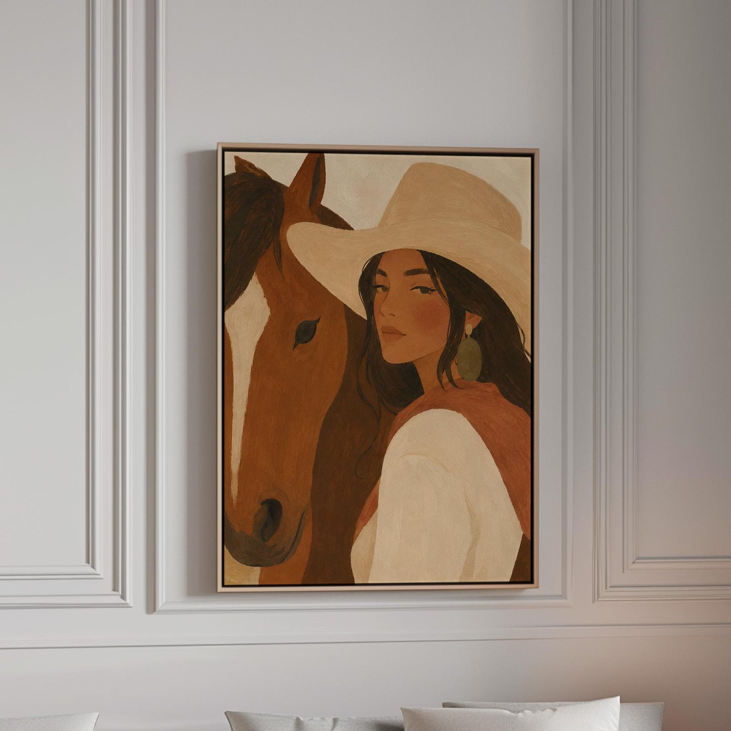 Cowgirl in a cream hat leaning cheek to cheek with a chestnut horse on warm tan, canvas print in a bright room with natural daylight