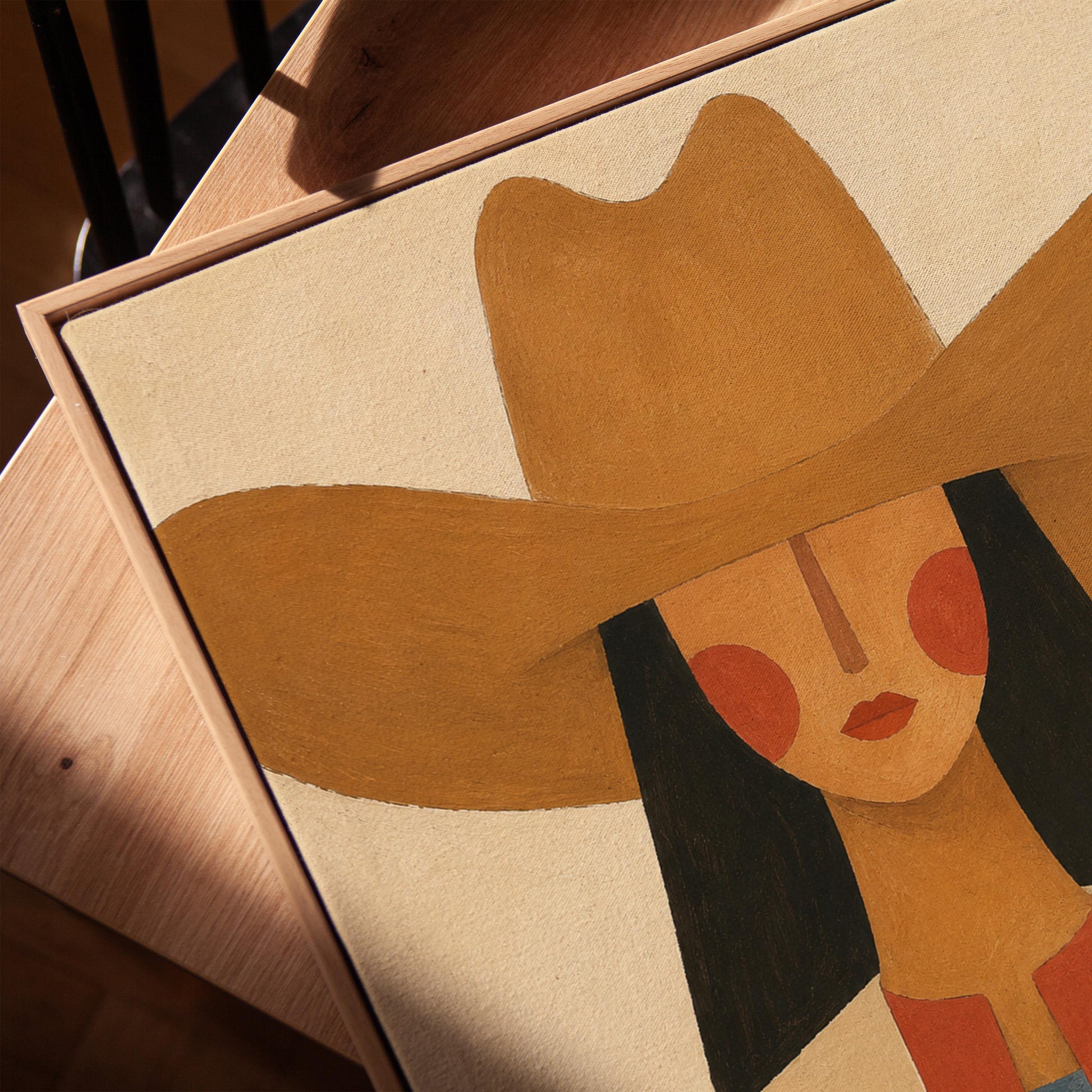 Folk cowgirl in a tan hat with rosy cheeks and a red aztec jacket on cream, canvas print in a warm, minimally styled interior