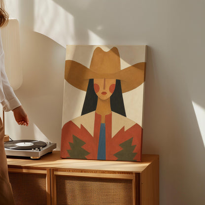 Folk cowgirl in a tan hat with rosy cheeks and a red aztec jacket on cream, canvas print styled against a soft white wall