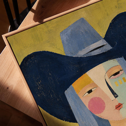 Cubist cowgirl with a big navy hat and multicolor face on olive yellow, canvas print in a warm, minimally styled interior