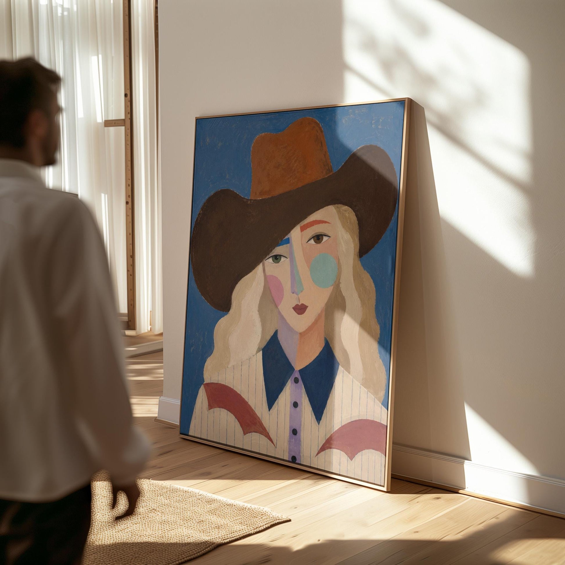 Blonde cowgirl in a rust hat with a cubist pastel face on deep blue, canvas print displayed on a neutral wall in a styled interior