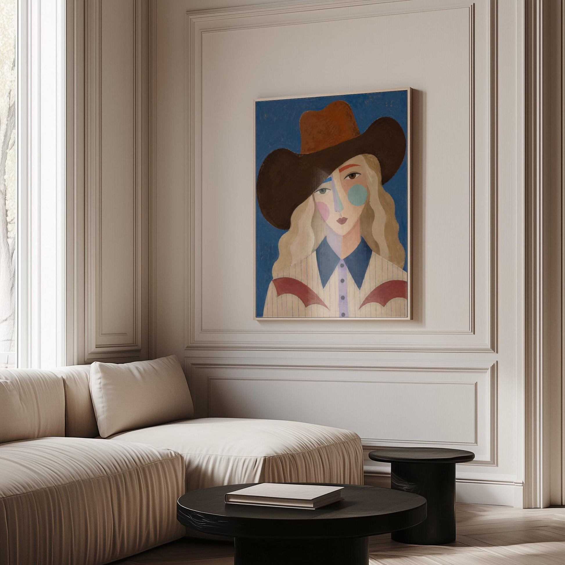 Blonde cowgirl in a rust hat with a cubist pastel face on deep blue, canvas print shown in a sunlit, contemporary room