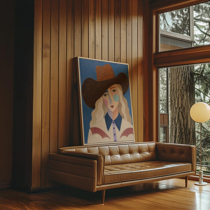 Blonde cowgirl in a rust hat with a cubist pastel face on deep blue, canvas wall art seen in a warm interior with natural light