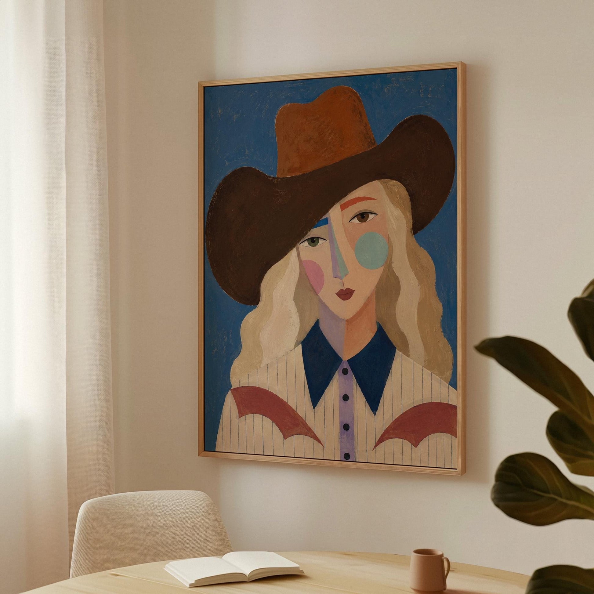 Blonde cowgirl in a rust hat with a cubist pastel face on deep blue, canvas wall art on a quiet wall in a considered interior