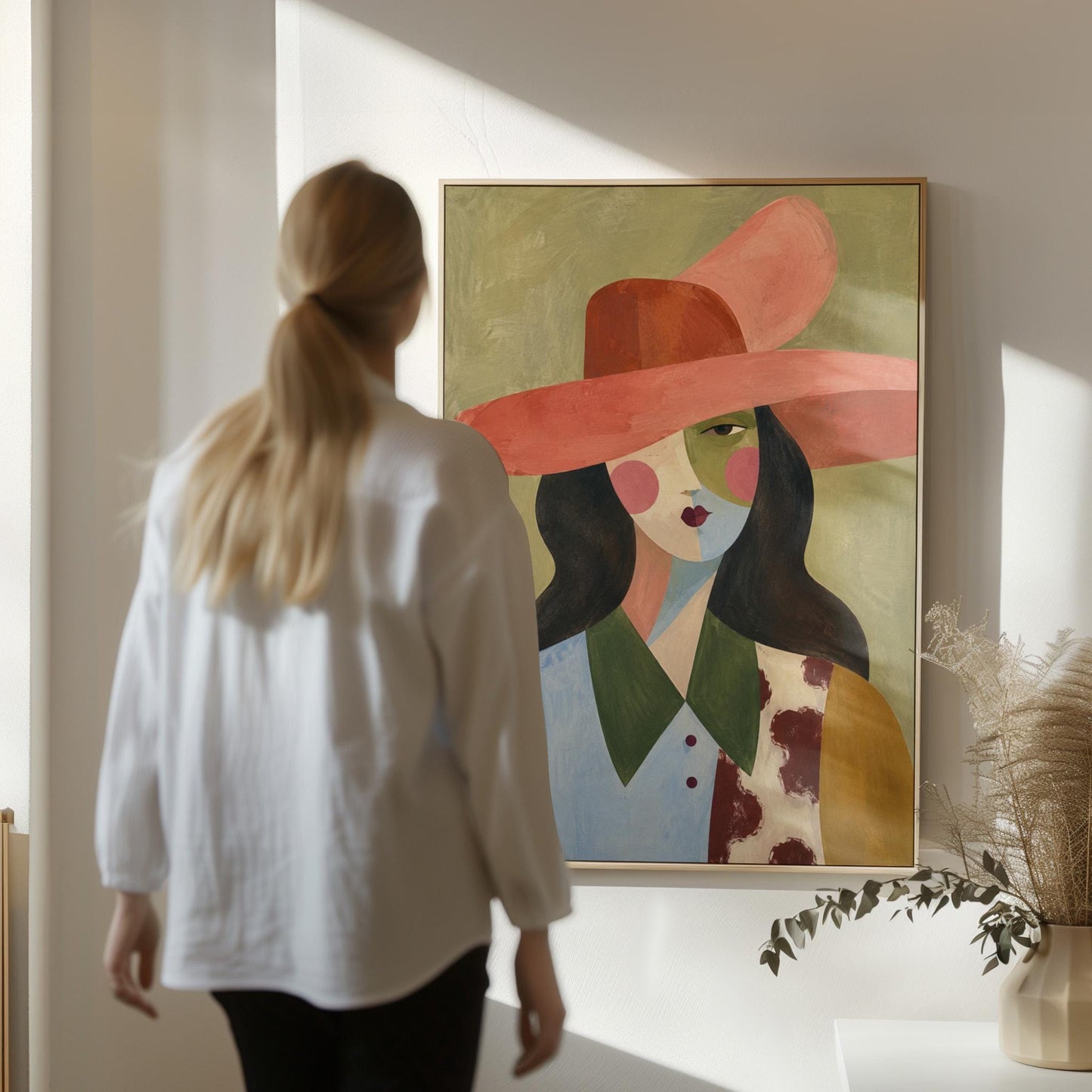 Abstract cowgirl in a wide coral hat with a cow print vest and dark hair, canvas print hanging in a calm, modern living space