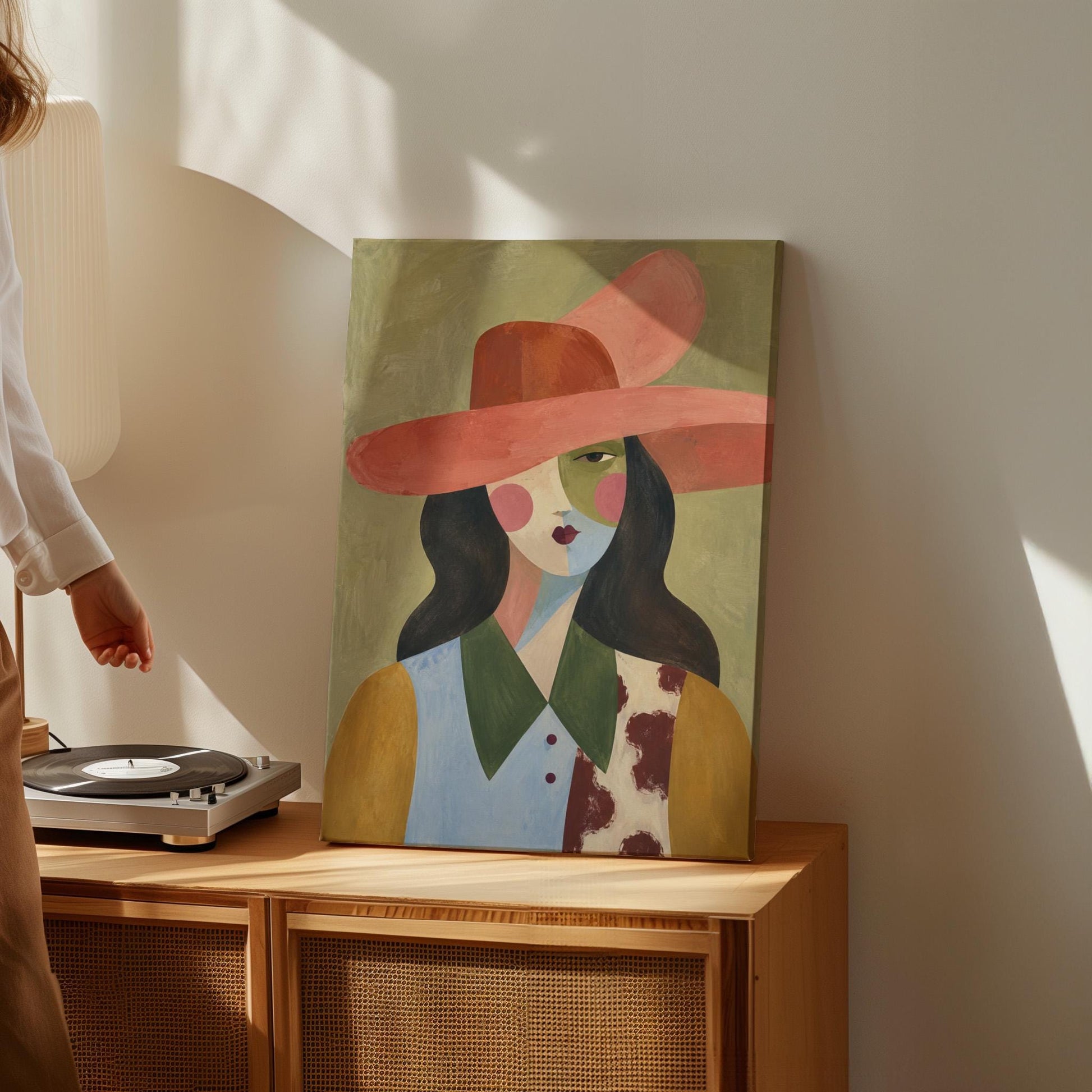 Abstract cowgirl in a wide coral hat with a cow print vest and dark hair, canvas wall art on a quiet wall in a considered interior