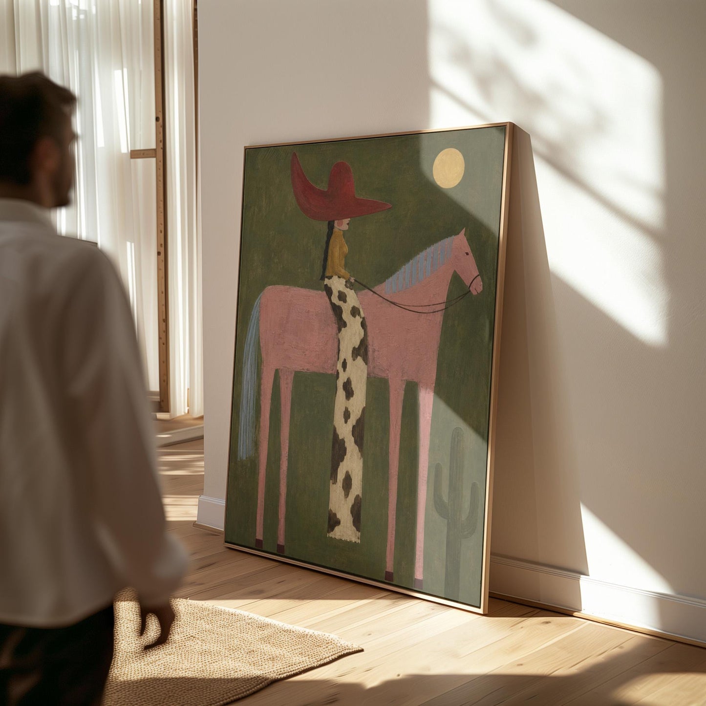 Cowgirl in a red hat riding a tall pink horse past a cactus under the moon, canvas wall art seen in a warm interior with natural light