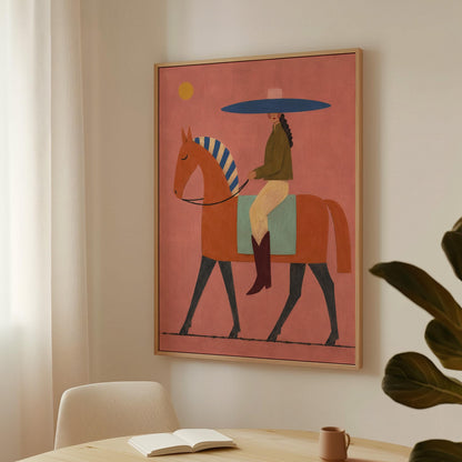 Cowgirl in a broad blue hat riding a rust red horse across a coral sky, canvas print presented in a light, minimal room