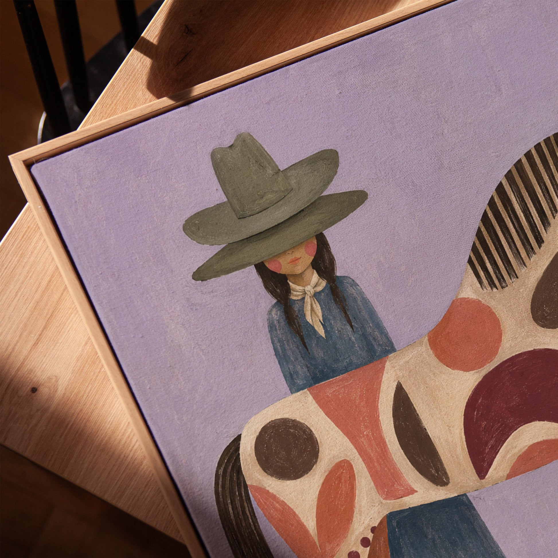 Woman in an olive hat before a patterned folk horse on a lavender ground, canvas print in a warm, minimally styled interior