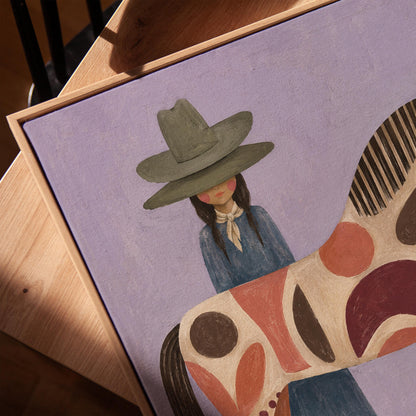 Woman in an olive hat before a patterned folk horse on a lavender ground, canvas print in a warm, minimally styled interior
