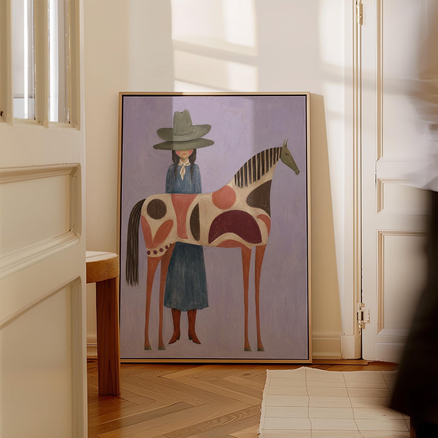 Woman in an olive hat before a patterned folk horse on a lavender ground, canvas print seen in a warm interior with natural light