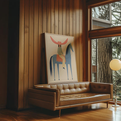 Cowgirl in a dramatic red hat riding a slender blue horse across pale sand, canvas print shown in a sunlit, contemporary room
