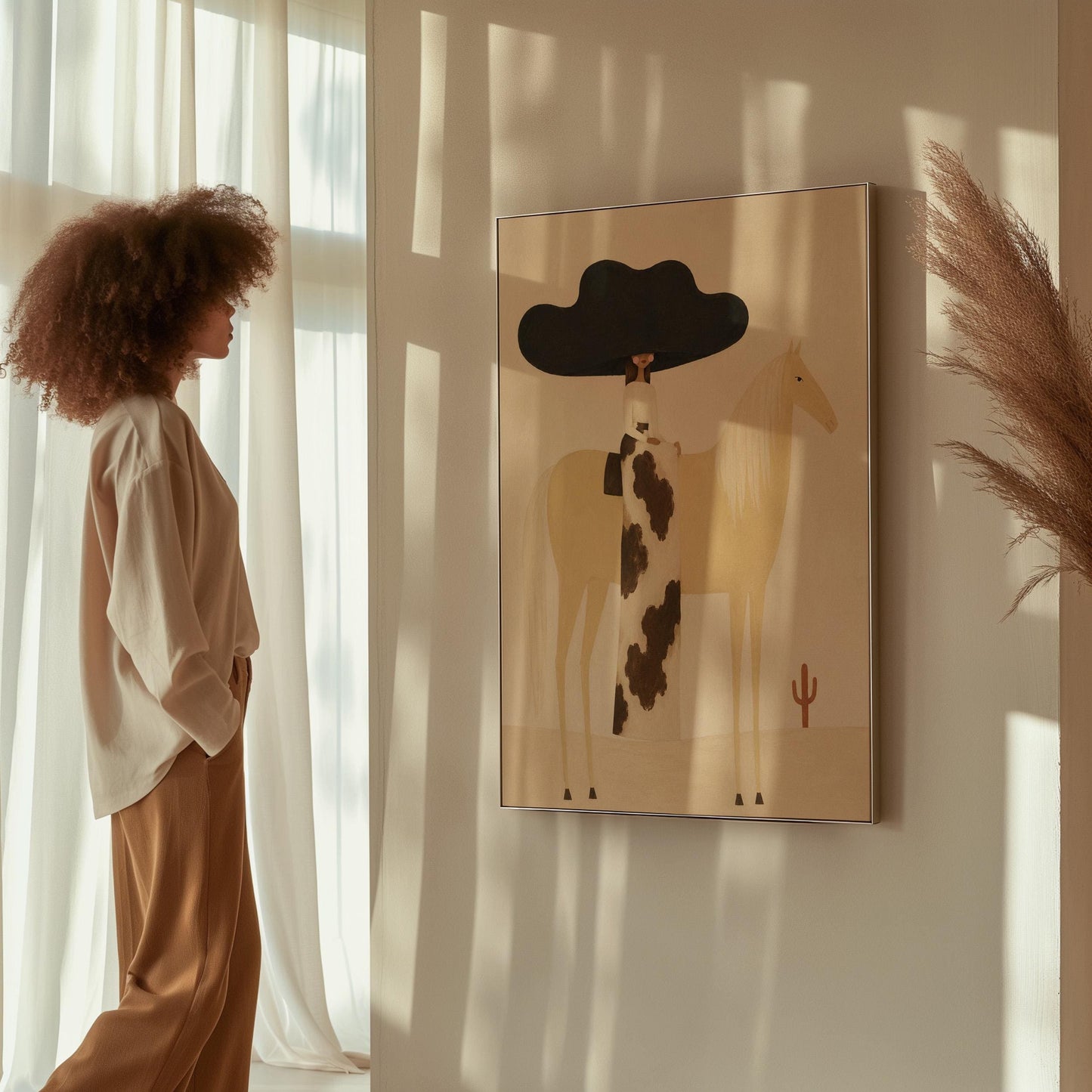 Woman in a huge black hat riding a pale palomino across a desert with cactus, canvas print styled against a soft white wall