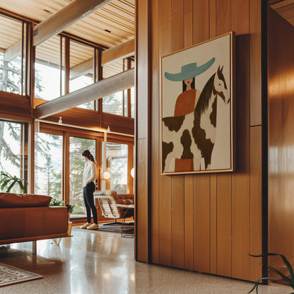 Woman in a teal hat beside a brown and white pinto horse in warm light, canvas wall art on a quiet wall in a considered interior