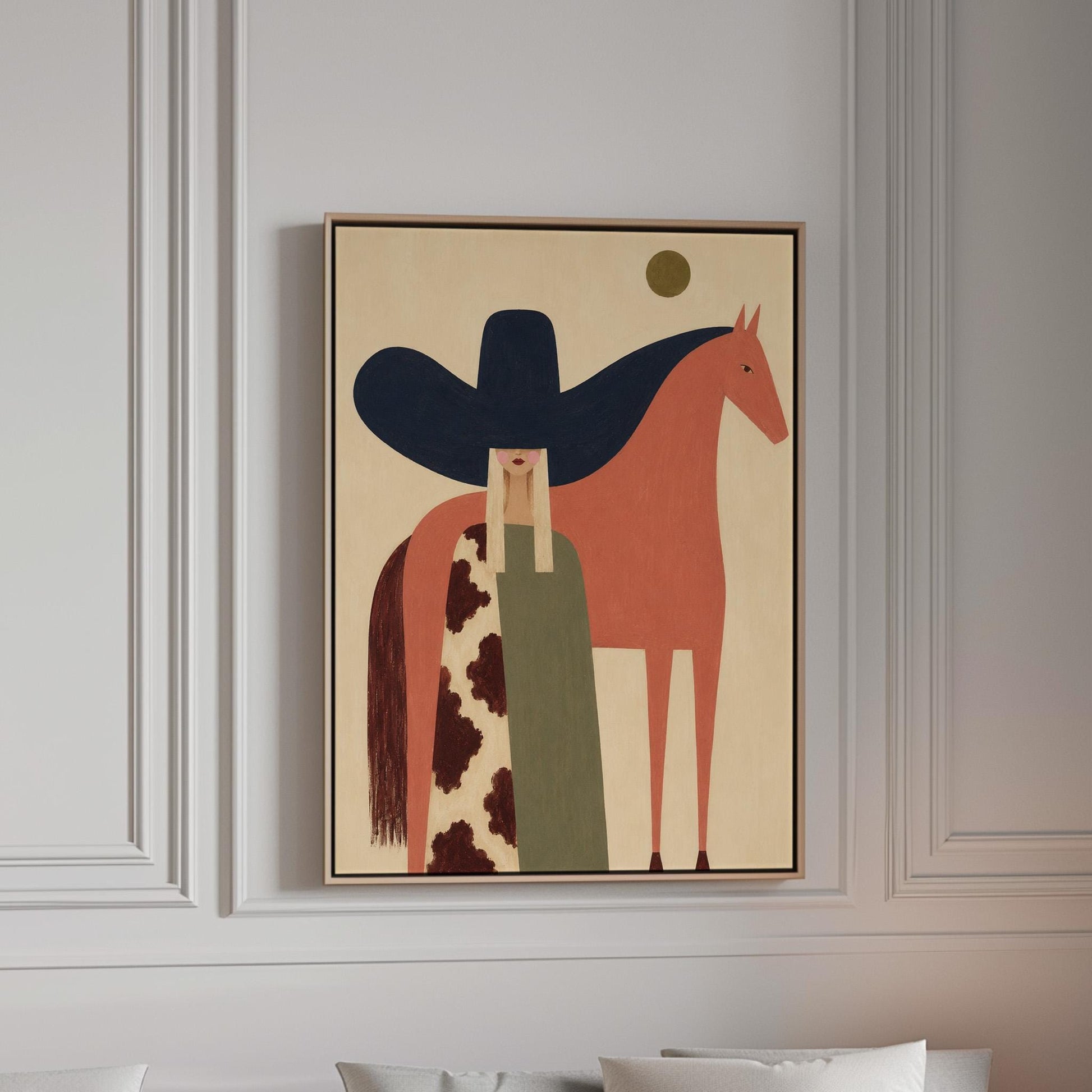 Cowgirl in a black sombrero and cow print cape beside a rust red horse, canvas print in a bright room with natural daylight