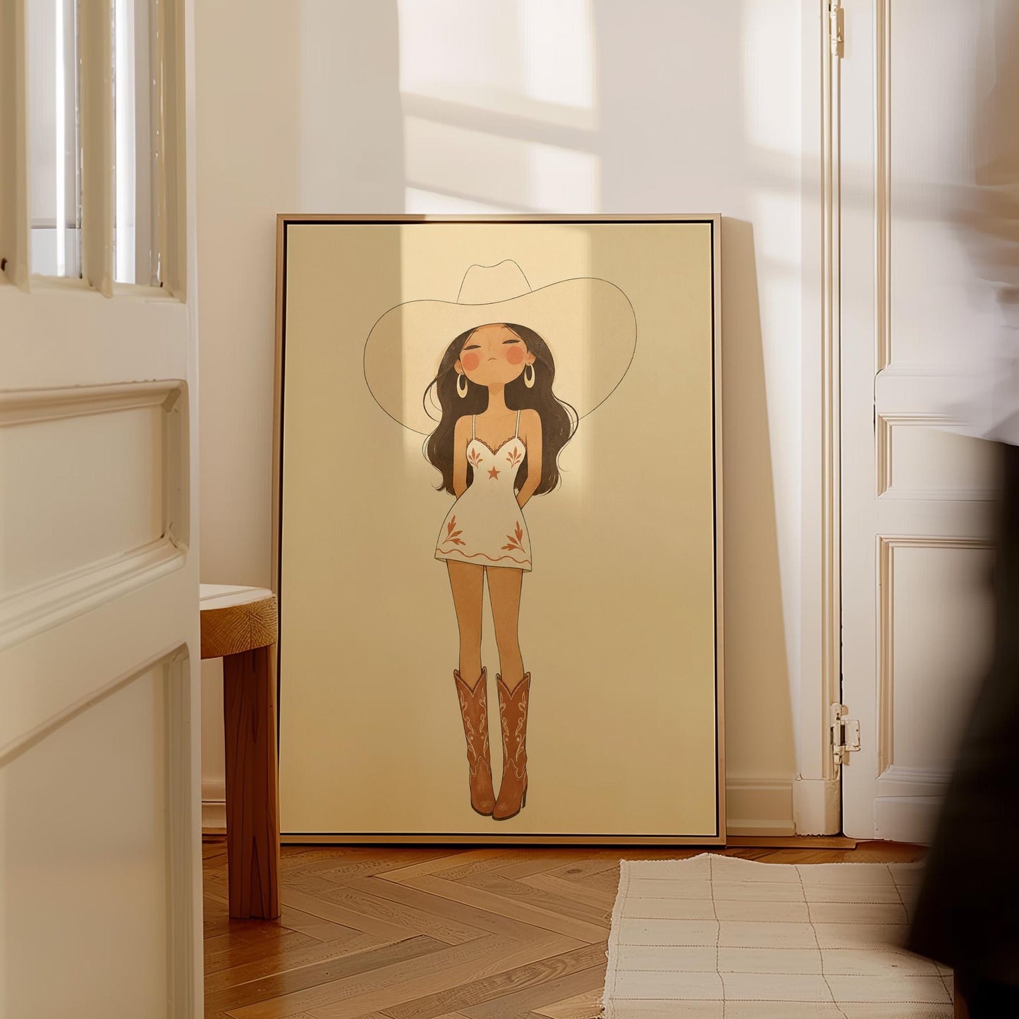 Cowgirl in a white dress, pale cowboy hat and tan boots on a cream ground, canvas wall art presented in a light, minimal room