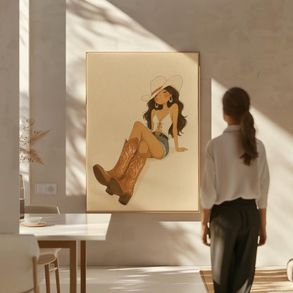 Cowgirl in denim shorts and cowboy boots leaning back under a wide pale hat, canvas print shown to scale in a furnished room